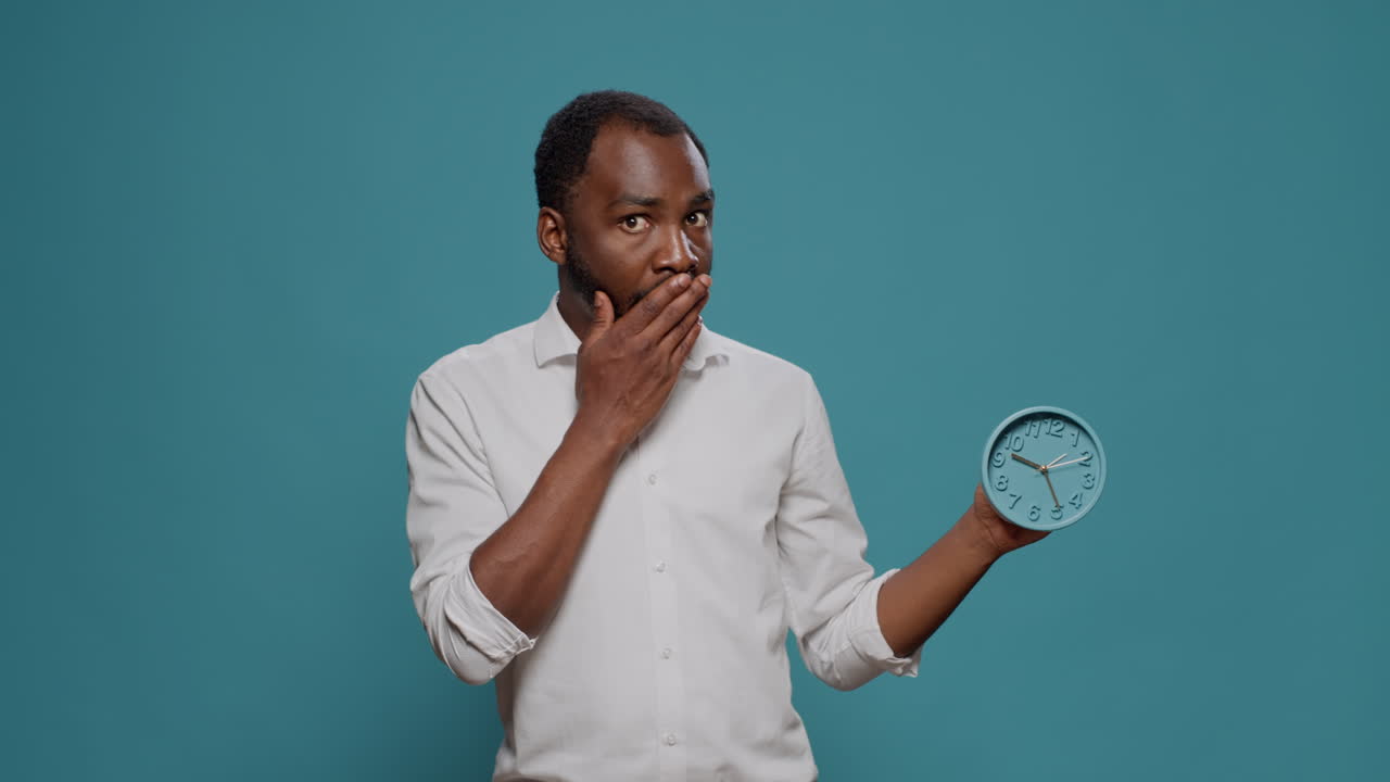 Man looking at a clock in shock