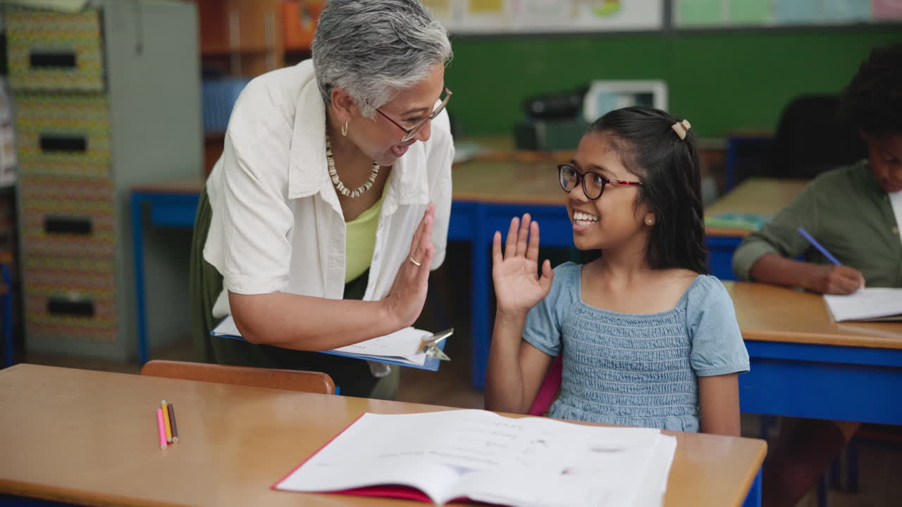 Teacher giving a high five to a student in the classroom