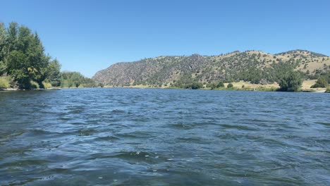 Blue-calm-river-on-windy-day-in-a-desert-valley-of-Montana