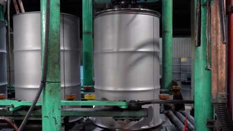 to ensure the drum reaches its precise size, a motor-driven machining tool operates on the top of each drum can