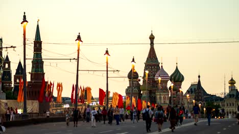 evening view of the st. basil's cathedral from the bolshoy moskvoretsky bridge with people walking on may 9