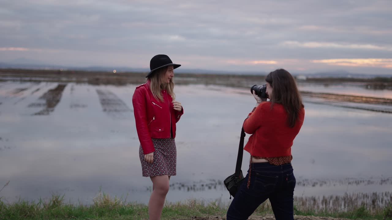 Women Taking Photos in a Paddy Field at Sunset