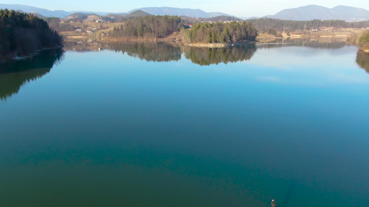 solitaire canoist training in calm water. Tranquil and serene Smartinsko lake