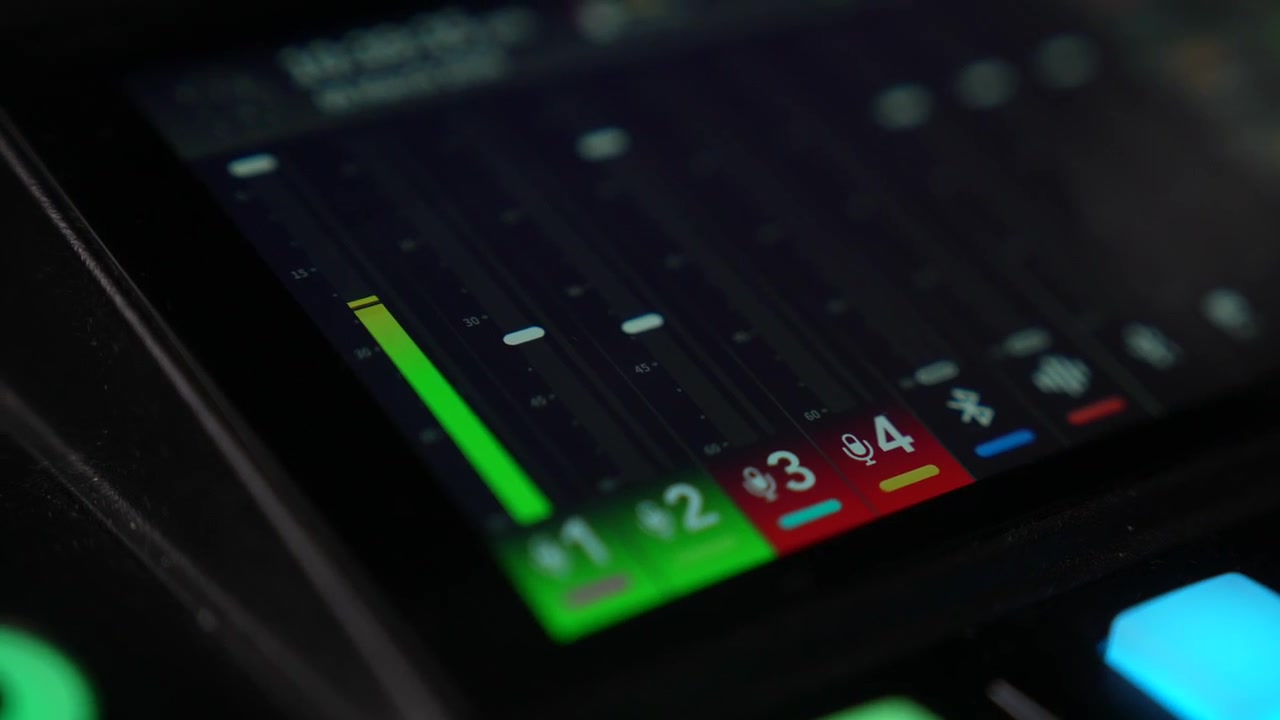 Audio mixer touch screen shows live volume levels changing on digital interface panel