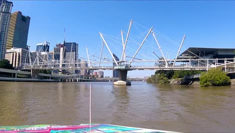 passenger ferry passes under unusual bridge