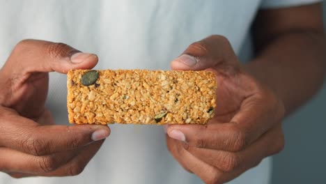 close-up of a granola bar held in hands