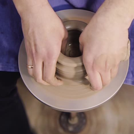 the hands of a potter make a jug on a potter's wheel 6