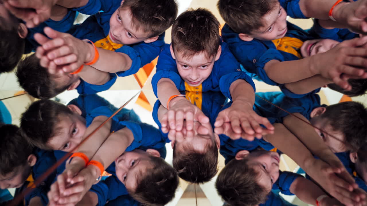 Many small triangles in kaleidoscope and curious boy in each one. Multicoloured pictures of a child in a kaleidoscope tunnel.