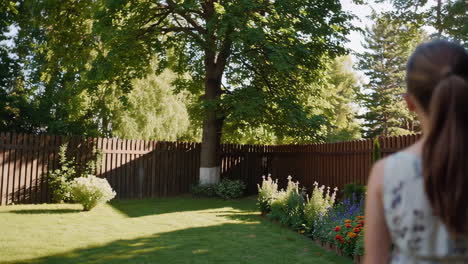 woman walking through a lush garden
