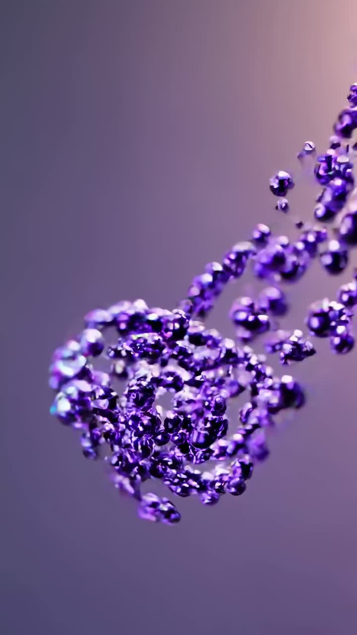 Close-up video of floating purple spheres in a spiral pattern against a soft gradient background