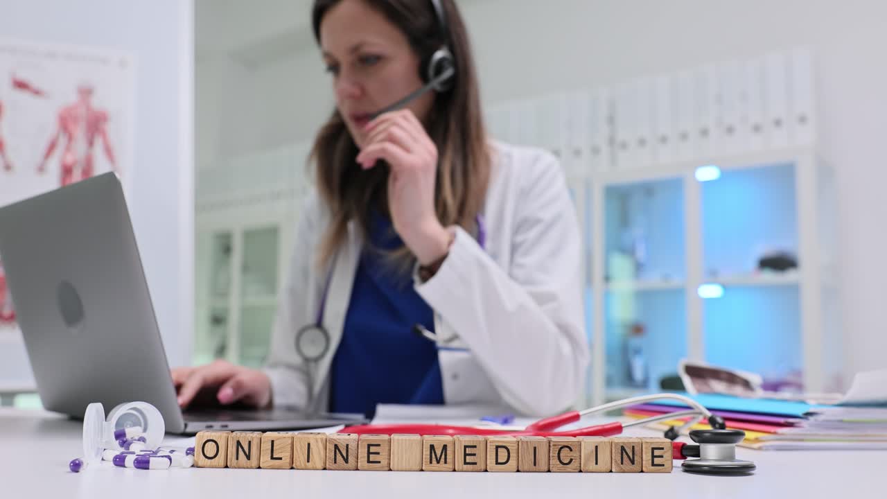 Bloques de madera forman la frase 'medicina en línea' mientras el médico realiza una consulta a distancia.