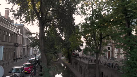 aerial early morning canal view of the nieuwe gracht in medieval dutch city of utrecht at sunrise rising between the trees at the upper street level