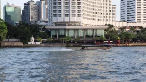 city skyline with boats moving on river