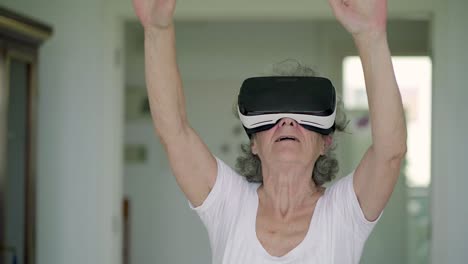 excited senior woman experiencing vr headset.