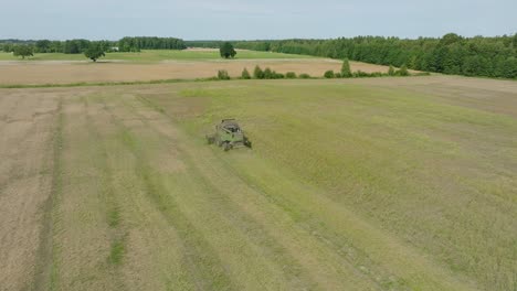 aerial establishing view of combine harvester mowing yellow wheat, dust clouds rise behind the machine, food industry, yellow reap grain crops, sunny summer day, drone shot moving forward, tilt down