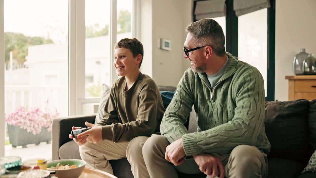 Father and son playing video games at home