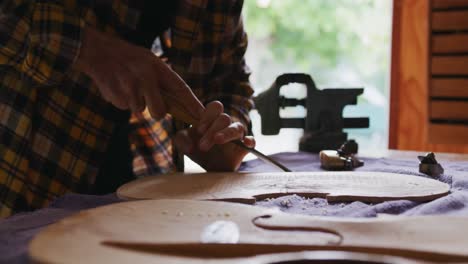 female luthier at work in her workshop