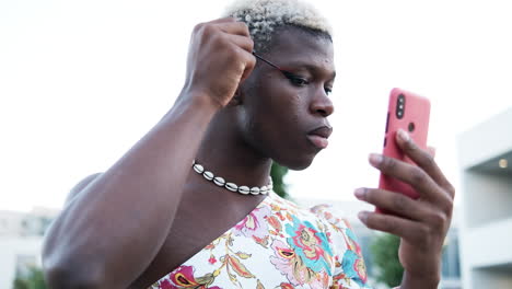 A person is applying makeup using a smartphone