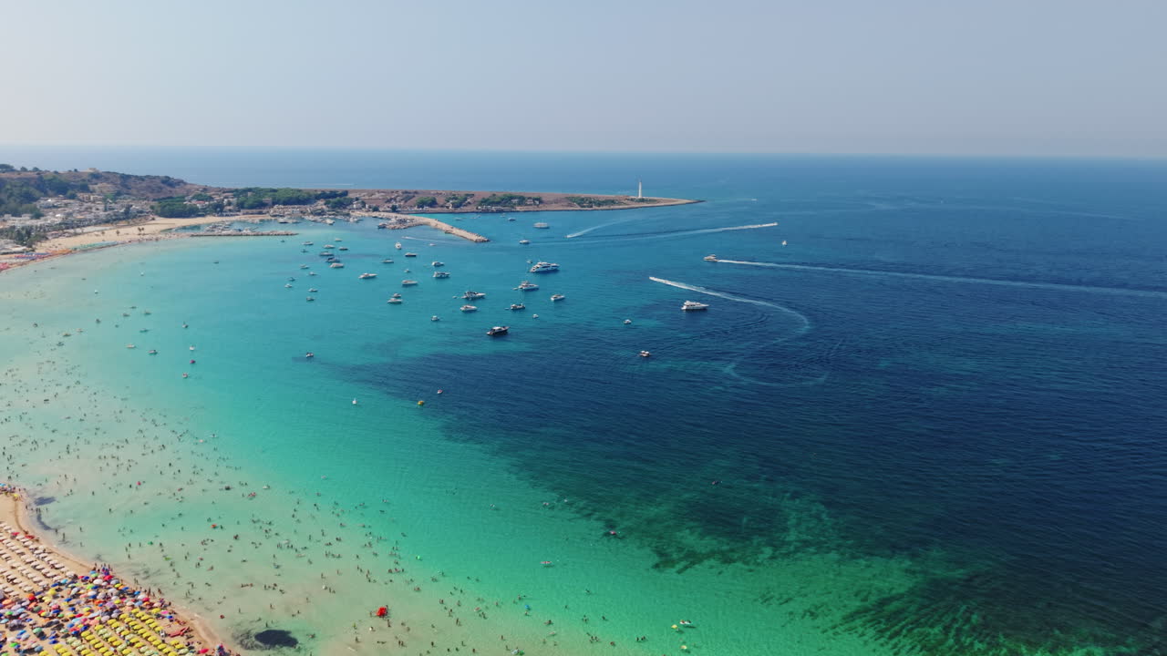 Aerial view of San Vito Lo Capo beach with boats on a sunny day