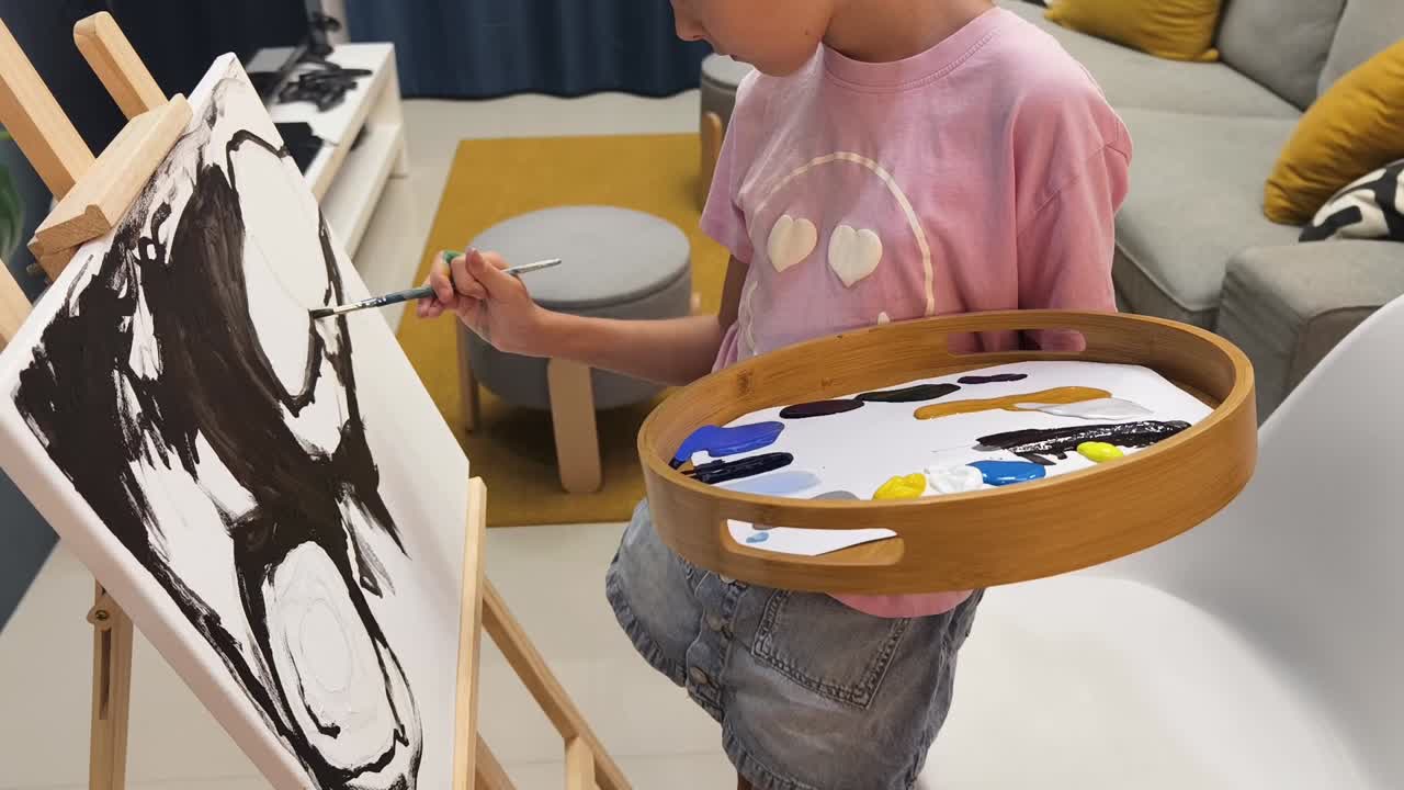Child painting abstract art in studio