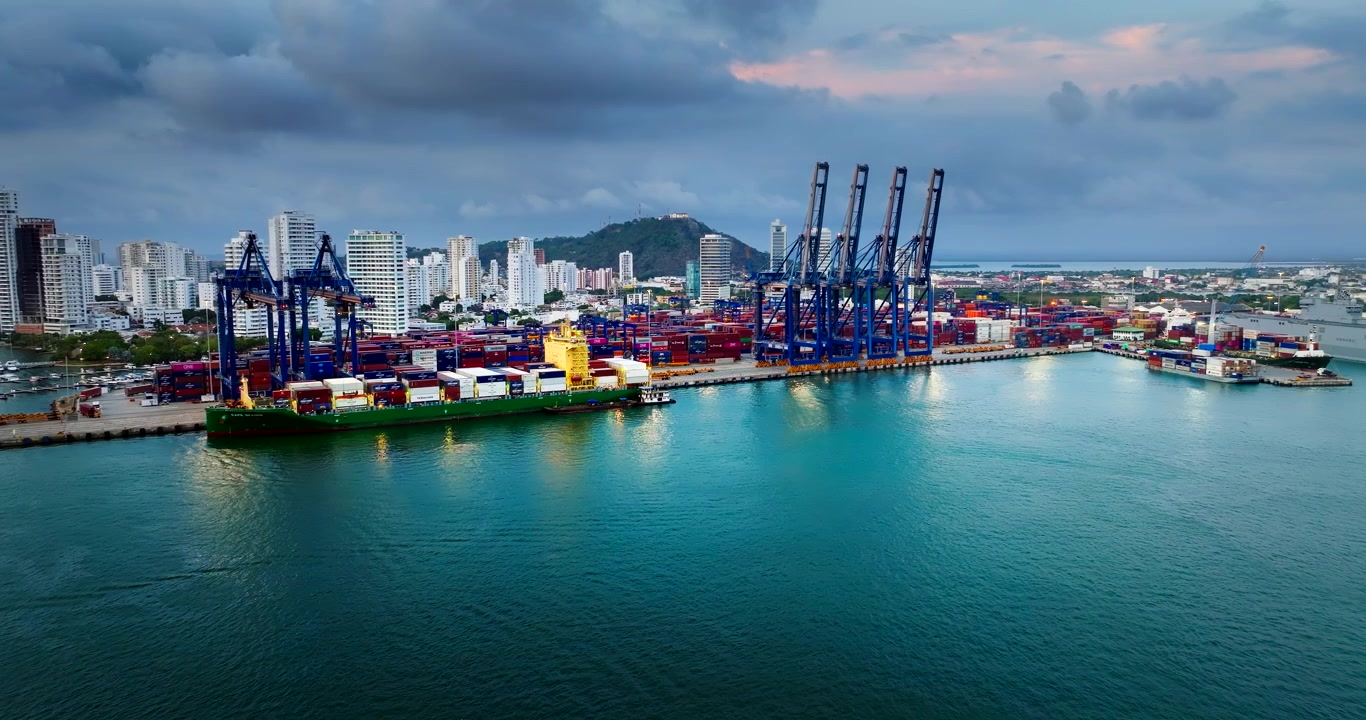 Cartagena container port with ship-to-shore cranes and docked vessel. Aerial
