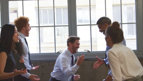 excited business team celebrating success at a meeting, close up