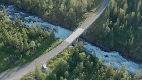 a two-lane road goes over a torrential flow in storforsen, norway