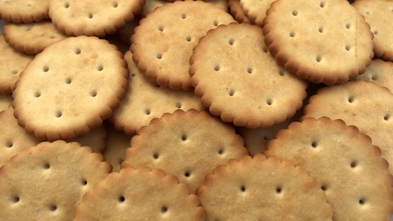Rotating cracker cookies background. Tasty food