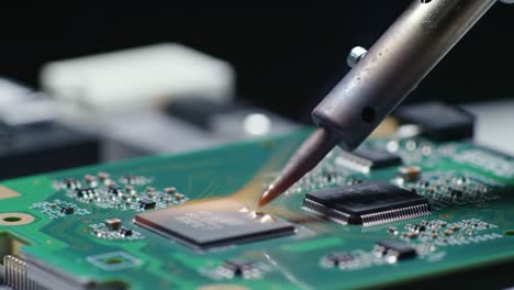 close-up process of soldering components on circuit boards, showcasing precision and heat application in electronics manufacturing