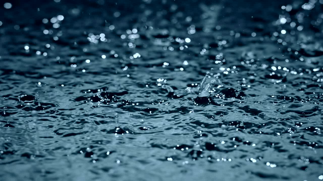 slow motion heavy rain water drops on surface street