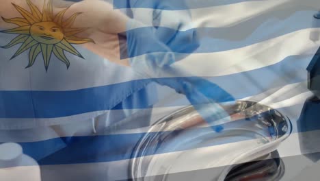 Animation-of-flag-of-uruguay-waving-over-surgeon-in-operating-theatre