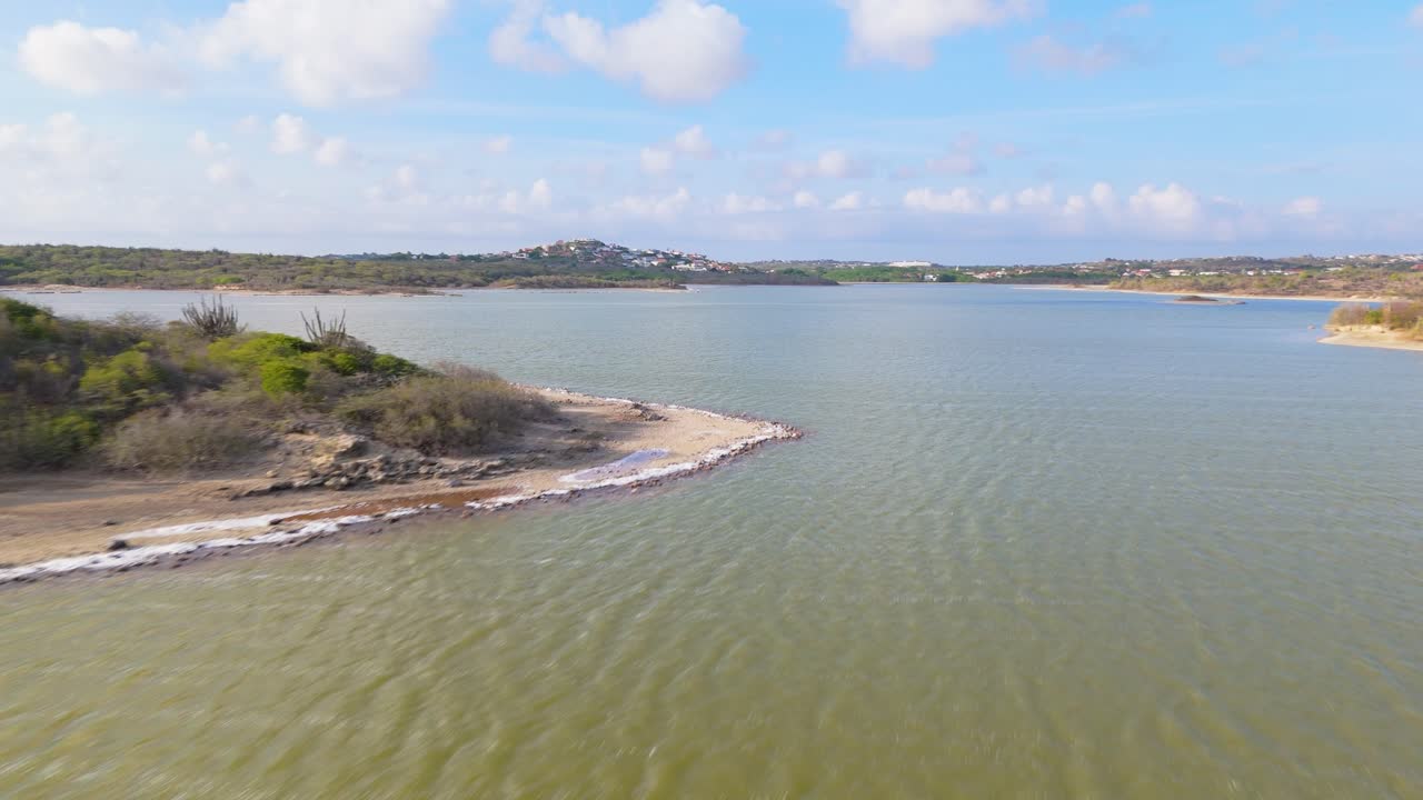Aerial overview of Jan Thiel salt pan, capturing calm water, scenic landscape, and surrounding vegetation