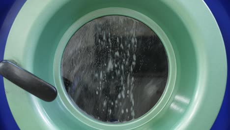 working washing machine in dry cleaning salon