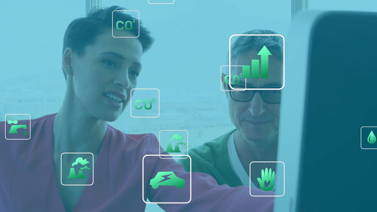 Floating green icons appearing, colleagues leaning and pointing at monitor, analyzing climate data