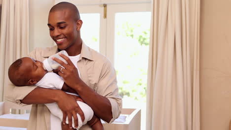 Happy-father-feeding-baby-son