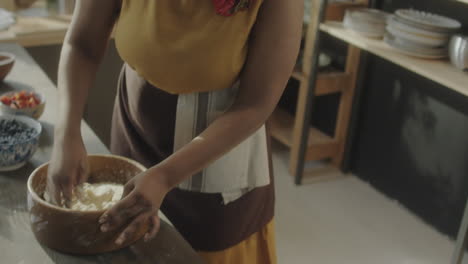 female culinary blogger kneading dough and talking on camera