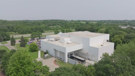 aerial pan shot of paisley park, princes house in chaska minnesota, usa during afternoon.