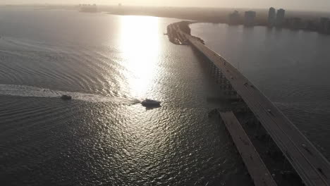 Establisher-aerial-view-of-William-Powell-Bridge-in-Miami,-Florida,-sunset