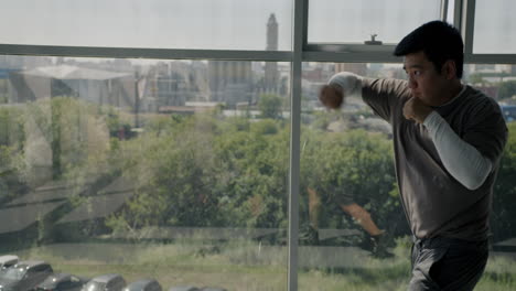 man boxing training by window