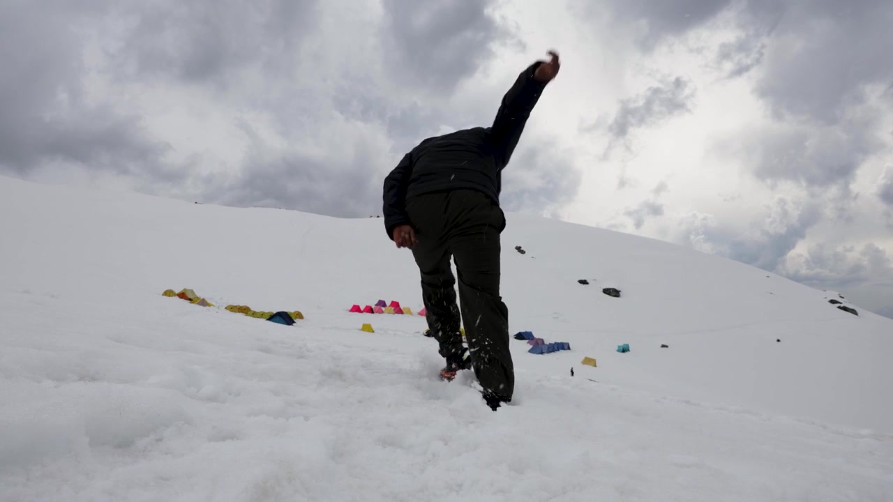 Trekker Losing Balance While Hiking Through Deep Snow on Mountain Slope