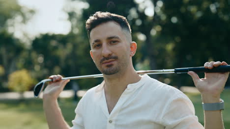 man holding golf club in park