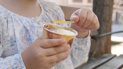 little girl enjoying ice-cream outdoor