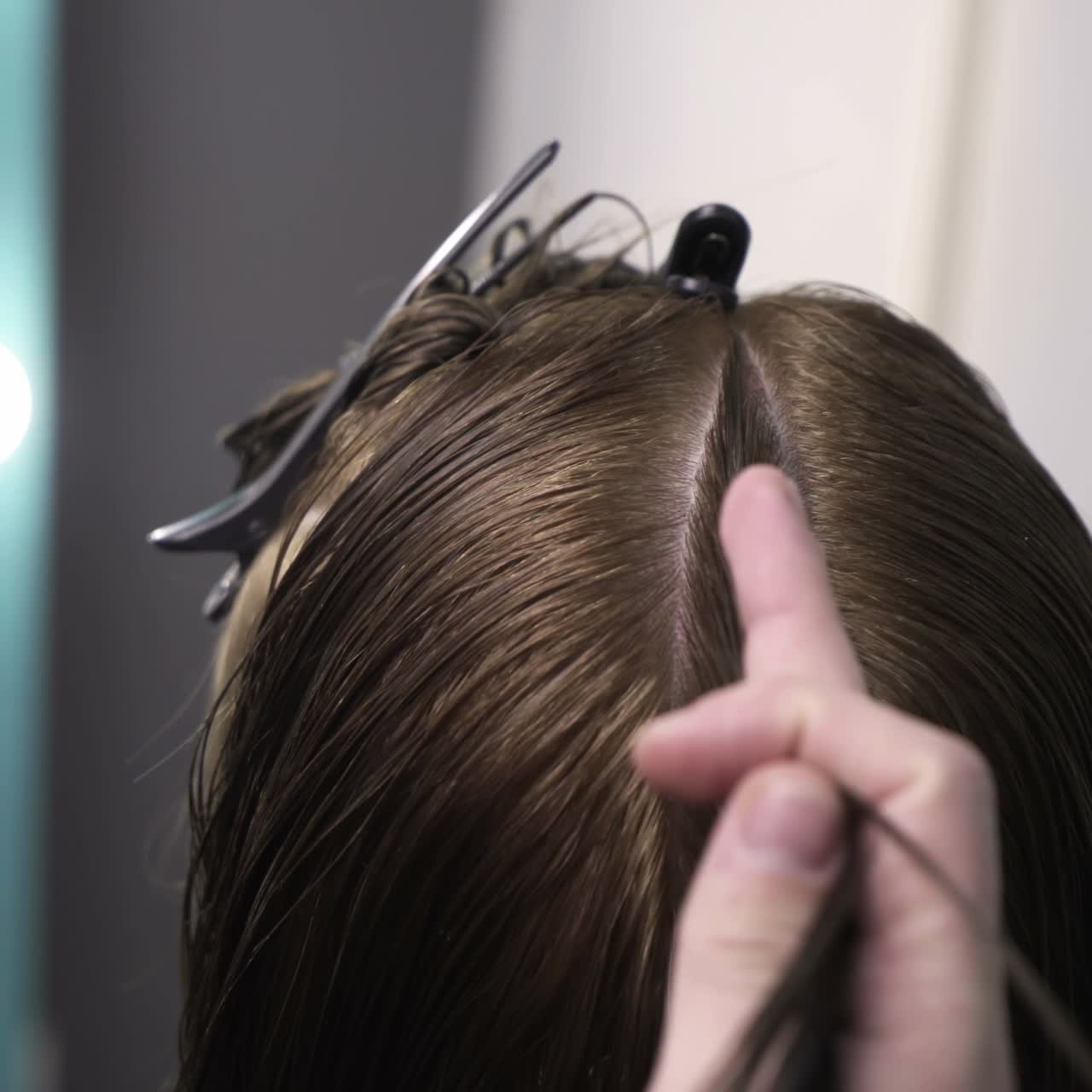 Hairdresser cutting hair of her customer