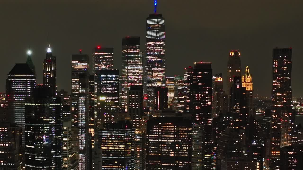 Vibrant night skyline of New York City captured from a drone