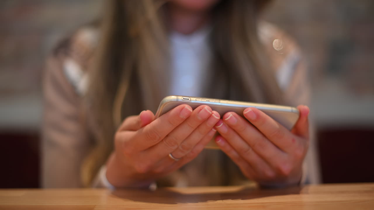 Woman working on mobile phone in a restaurant