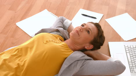 Happy pretty woman lying on the floor