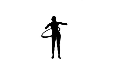 silhouette woman playing with a hula hoop