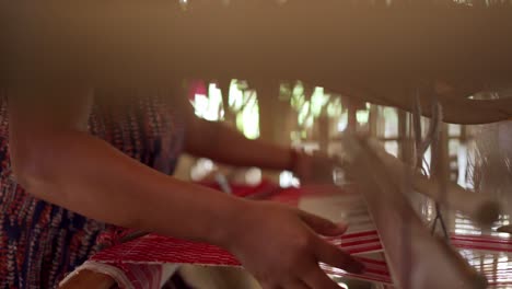 woman-labor-weaving-cotton-in-indian-workshop-close-up-of-working-hands