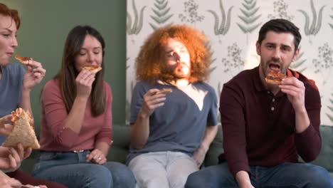 diverse friends cheering up for woman bringing pizzas during weekend party at home