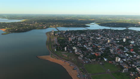 aerial drone fly san jose beach at encarnación city paraguay, drone landscape above paraná river, border with argentina